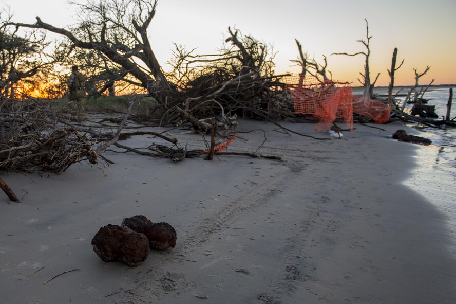 U.S. Air Force Explosive Ordnance Disposal technicians work with local law enforcement bomb squad members to transport Civil War cannonballs washed ashore from  Hurricane Mathew to a safe location at Folly Beach, S.C., Oct. 9, 2016. After the discovery of ordnance on the beach local law enforcement and the Air Force worked together to properly dispose of the hazards.  