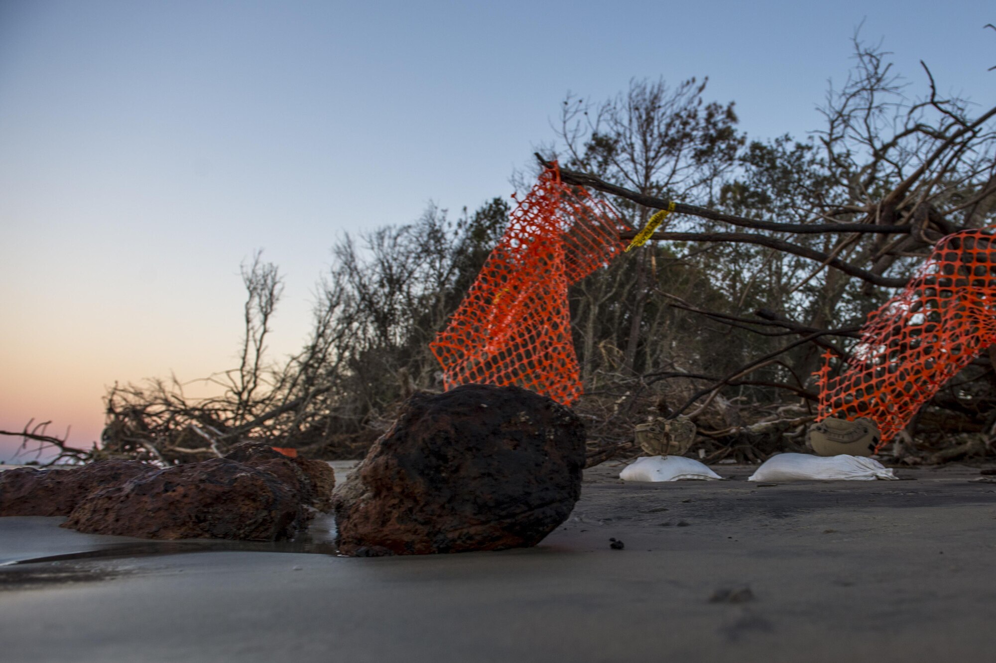 U.S. Air Force Explosive Ordnance Disposal technicians work with local law enforcement bomb squad members to transport Civil War cannonballs washed ashore from  Hurricane Mathew to a safe location at Folly Beach, S.C., Oct. 9, 2016. After the discovery of ordnance on the beach local law enforcement and the Air Force worked together to properly dispose of the hazards.  