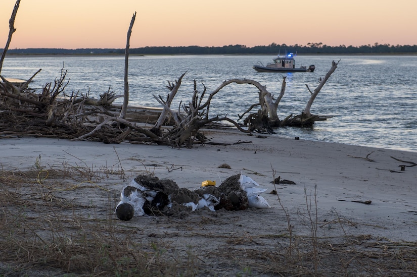 U.S. Air Force Explosive Ordnance Disposal technicians work with local law enforcement bomb squad members to transport Civil War cannonballs washed ashore from  Hurricane Matthew to a safe location at Folly Beach, S.C., Oct. 9, 2016. After the discovery of ordnance on the beach, local law enforcement and Air Force personnel worked together to properly dispose of the hazards.  