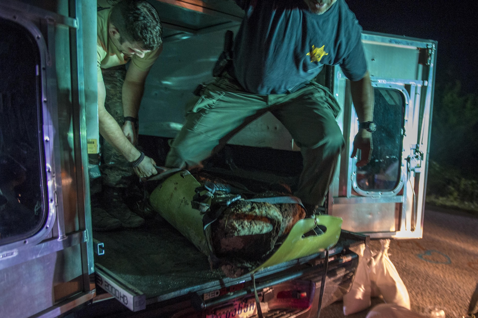 U.S. Air Force Explosive Ordnance Disposal technicians work with local law enforcement bomb squad members to transport Civil War cannonballs washed ashore from  Hurricane Matthew to a safe location at Folly Beach, S.C., Oct. 9, 2016. After the discovery of ordnance on the beach, local law enforcement and Air Force personnel worked together to properly dispose of the hazards. 