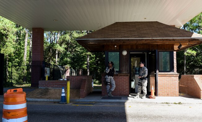 U.S. Air Force Senior Airmen Jasmine Jamison and Rachel Mayner, patrol officers with the 628th Security Forces Squadron guard the gates after Hurricane Matthew swept the area on Joint Base Charleston - Naval Weapons Station, S.C., Oct. 9, 2016. All non-essential personnel evacuated the area, but returned after disaster response coordinators assessed damage and verified a safe operating environment. 