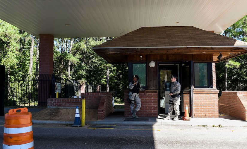 U.S. Air Force Senior Airmen Jasmine Jamison and Rachel Mayner, patrol officers with the 628th Security Forces Squadron guard the gates after Hurricane Matthew swept the area on Joint Base Charleston - Naval Weapons Station, S.C., Oct. 9, 2016. All non-essential personnel evacuated the area, but returned after disaster response coordinators assessed damage and verified a safe operating environment. 