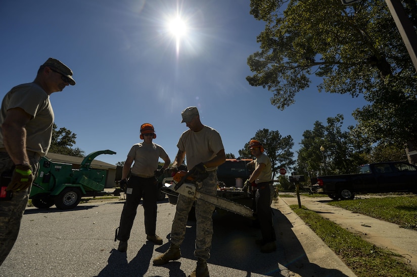 U.S. Air Force civil engineers with the 628th Civil Engineer Squadron remove debris on Hunley Park-Air Base housing done by Hurricane Matthew on Joint Base Charleston, S.C., Oct. 9, 2016. All non-essential personnel evacuated the area, but returned after disaster response coordinators assessed damage and verified a safe operating environment. 