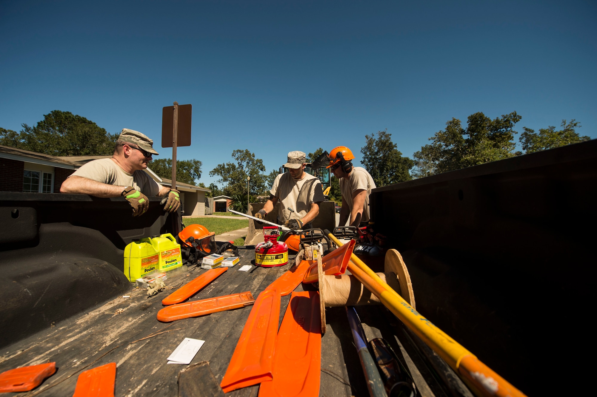 U.S. Air Force civil engineers with the 628th Civil Engineer Squadron remove fallen trees on Hunley Park-Air Base housing done by Hurricane Matthew on Joint Base Charleston, S.C., Oct. 9, 2016. All non-essential personnel evacuated the area, but returned after disaster response coordinators assessed damage and verified a safe operating environment. 