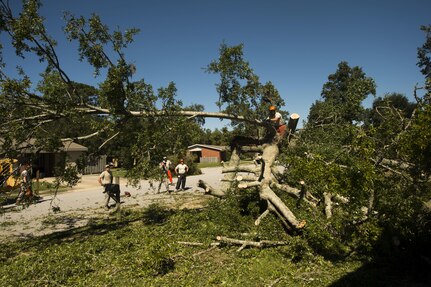 U.S. Air Force civil engineers with the 628th Civil Engineer Squadron remove fallen trees on Hunley Park-Air Base housing done by Hurricane Matthew on Joint Base Charleston, S.C., Oct. 9, 2016. All non-essential personnel evacuated the area, but returned after disaster response coordinators assessed damage and verified a safe operating environment. 