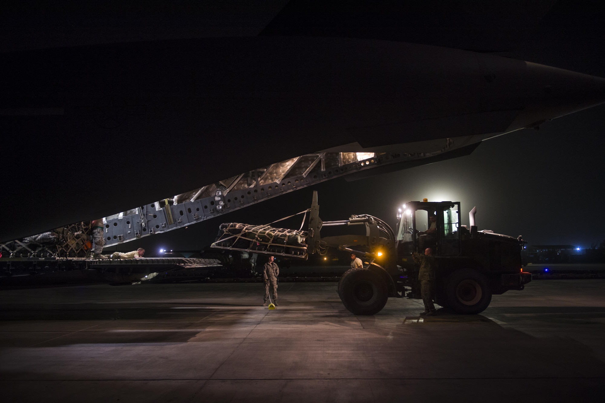U.S. Air Force C-17 Globemaster III crewmembers load cargo during a transport mission in support of Operation Freedom Sentinel in Southwest Asia Sept. 30, 2016. The C-17 is the newest most flexible cargo aircraft to enter the airlift force. The C-17 is capable of rapid strategic delivery of troops and all types of cargo to main operating bases or directly to forward bases in the deployment area. (U.S. Air Force photo by Staff Sgt. Douglas Ellis/Released)
