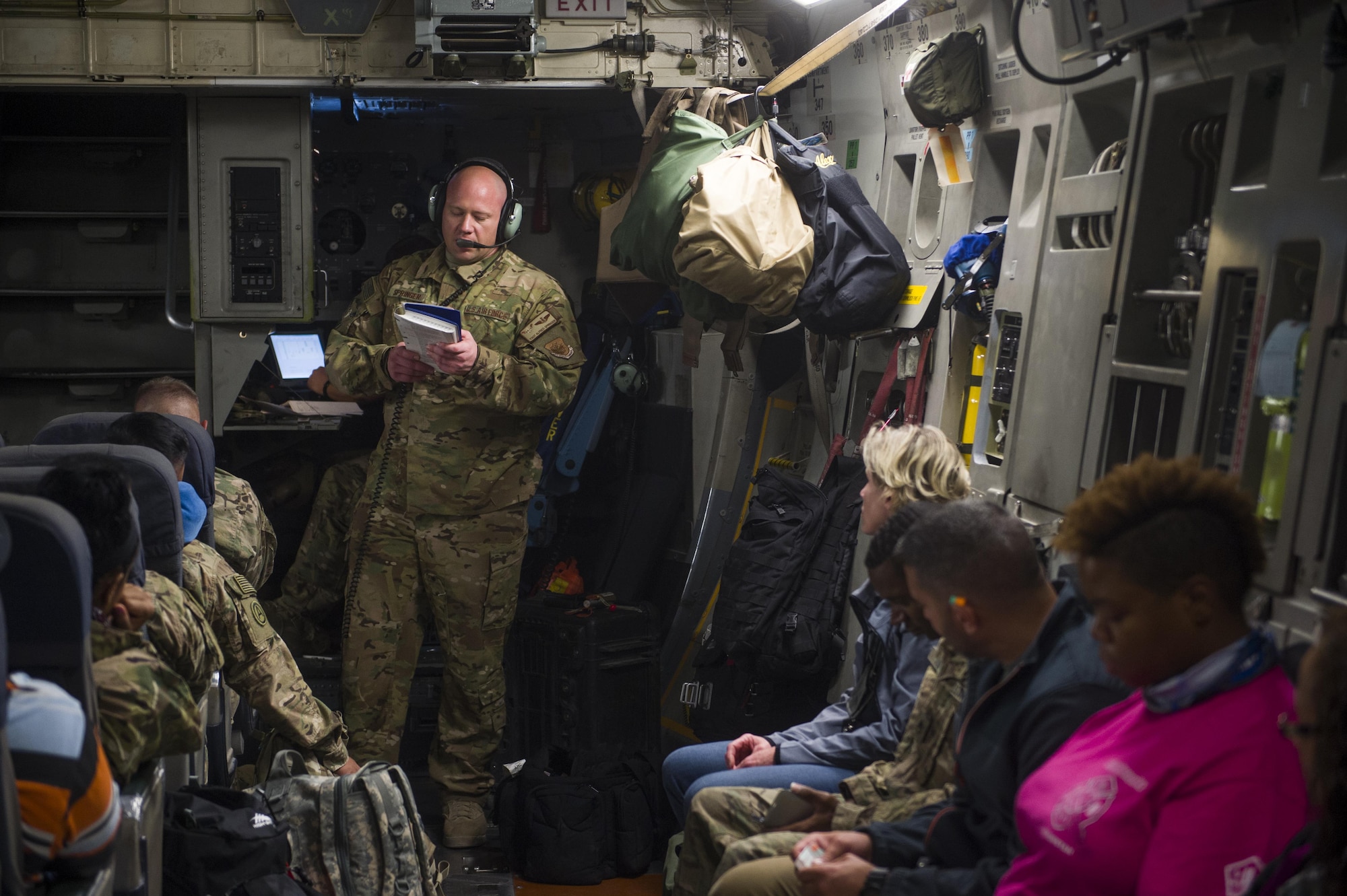 A U.S. Air Force C-17 Globemaster III loadmaster briefs passengers on in-flight emergency procedures during a transport mission in support of Operation Freedom Sentinel in Southwest Asia Sept. 30, 2016. The C-17 is the newest most flexible cargo aircraft to enter the airlift force. The C-17 is capable of rapid strategic delivery of troops and all types of cargo to main operating bases or directly to forward bases in the deployment area. (U.S. Air Force photo by Staff Sgt. Douglas Ellis/Released)