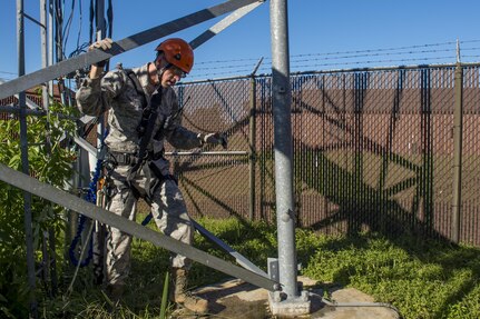 U.S. Air Force Senior Airman Anthony Tressel, radio frequency transmission technician with the 628th Communications Squadron, inspects a ultra high frequency (UHF) antenna for wind damage caused by Hurricane Matthew  on Joint Base Charleston, S.C., Oct. 10, 2016. Joint Base personnel are working diligently to return the Joint Base to full operational status after disaster response coordinators assessed damage and verified a safe operating environment.