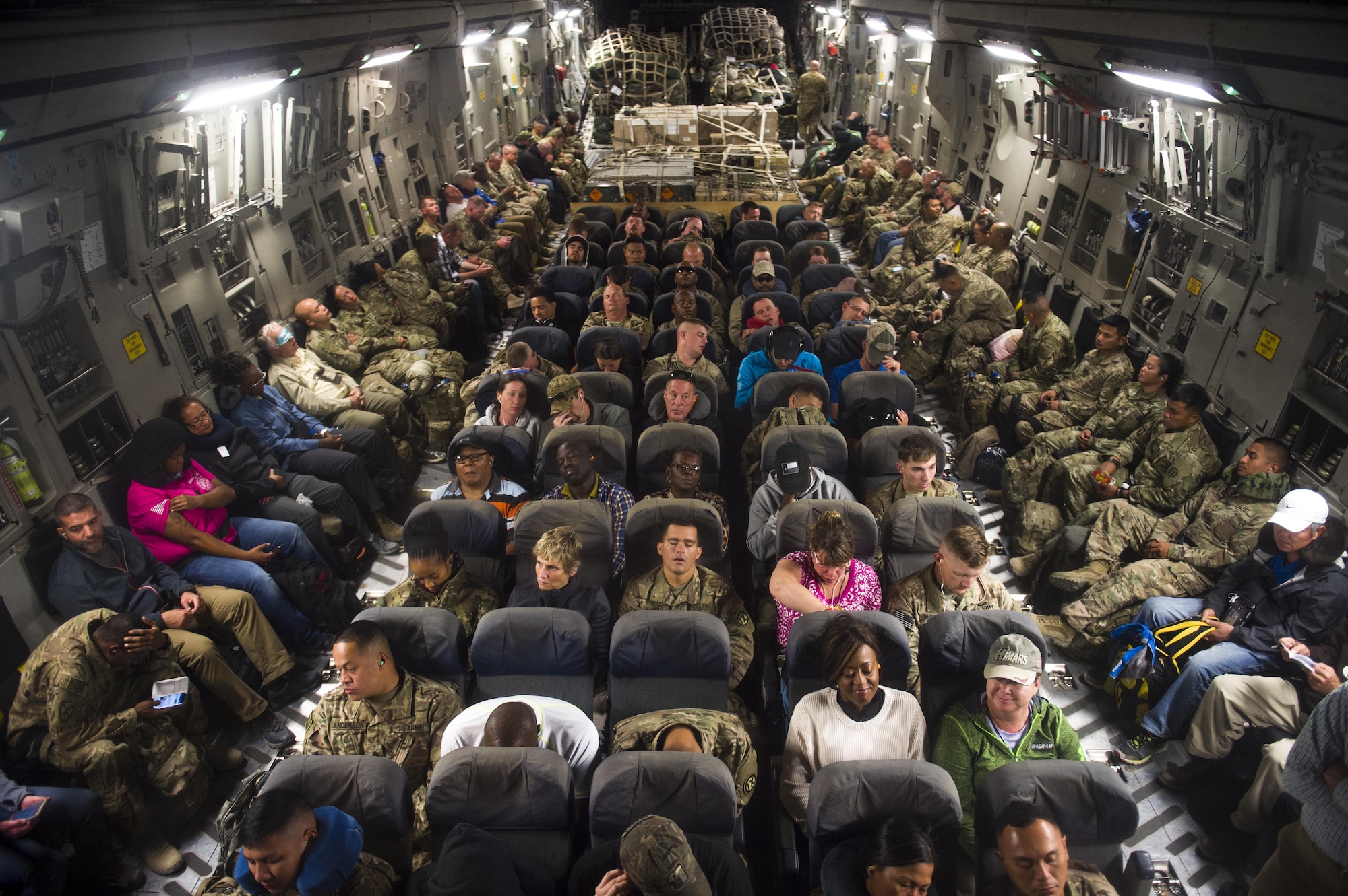 Passengers rest on a C-17 Globemaster III during a transport mission in support of Operation Freedom Sentinel in Southwest Asia Sept. 30, 2016. The C-17 is the newest most flexible cargo aircraft to enter the airlift force. The C-17 is capable of rapid strategic delivery of troops and all types of cargo to main operating bases or directly to forward bases in the deployment area. (U.S. Air Force photo by Staff Sgt. Douglas Ellis/Released)