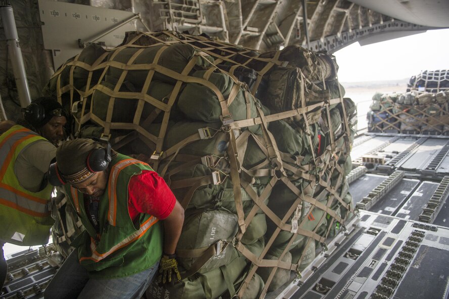 Cargo is offloaded from a C-17 Globemaster III loadmaster during a transport mission in support of Operation Freedom Sentinel in Southwest Asia Sept. 30, 2016. The C-17 is the newest most flexible cargo aircraft to enter the airlift force. The C-17 is capable of rapid strategic delivery of troops and all types of cargo to main operating bases or directly to forward bases in the deployment area. (U.S. Air Force photo by Staff Sgt. Douglas Ellis/Released)