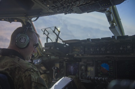 A U.S. Air Force C-17 Globemaster III pilot looks at his notes during a transport mission in support of Operation Freedom Sentinel in Southwest Asia Sept. 30, 2016. The C-17 is the newest most flexible cargo aircraft to enter the airlift force. The C-17 is capable of rapid strategic delivery of troops and all types of cargo to main operating bases or directly to forward bases in the deployment area. (U.S. Air Force photo by Staff Sgt. Douglas Ellis/Released)