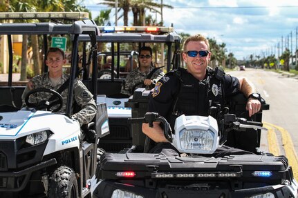 Officer Thomas Ashlock patrols the neighborhoods of St. Augustine Beach with his own Soldiers from the 221st Ordnance Company (EOD), shortly after hurricane Matthew disrupted the beach community.  Ashlock not only aids his community as a law enforcement officer, he also serves in the Florida Army National Guard as the commander of the 221st Ordnance Company. 