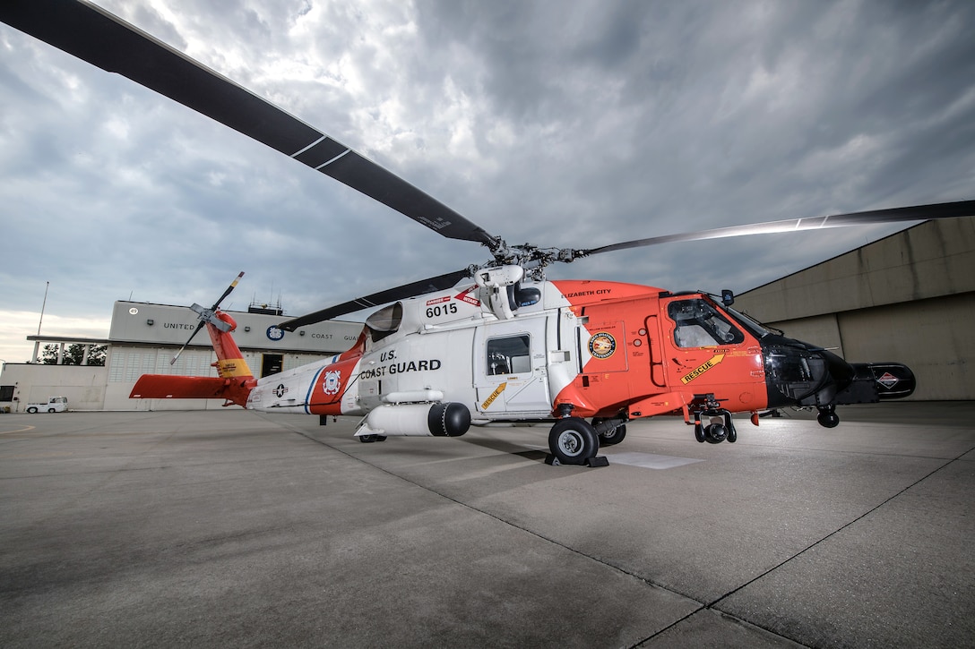 A U.S. Coast Guard Jayhawk Helicopter stands tall at Air Station Elizabeth City, North Carolina on Sunday, June 12, 2016. At Air Station Elizabeth City, C-130 Hercules and H-60 Jayhawk aircrews are ready to respond to calls for assistance 24 hours a day. U.S. Coast Guard illustration by Auxiliarist David Lau.