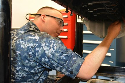 Seaman Jacob Pruett reaches into the cylinder of a marine diesel engine to guide the connecting rod and piston down gently. Pruett works in the Diesel Shop at Southeast Regional Maintenance Center (SERMC). Enginemen operate, maintain and repair internal combustion engines, main propulsion machinery, refrigeration, air conditioning, gas trubine engines and other auxiliary equipment onboard Navy ships.