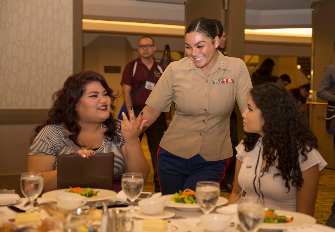 Capt. Evita Mosqueda-Chapman, Recruiting Support Officer for Recruiting Station San Diego, engages with students during the Latinos in Science and Engineering Chapter (MAES) Officers' Luncheon at the Great Minds in STEM Hispanic Engineering National Achievement Award Conference in Anaheim, Calif., Oct. 6, 2016. During the conference Marines interact with collegiate-level students from across the country, all which have a Hispanic heritage, and have shown outstanding qualities in education and leadership. (U.S. Marine Corps Photo by Sgt. Taylor Morton/Released)