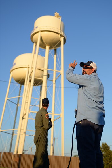 A 47th Civil Engineering Squadron contractor counts down to the lighting of the Laughlin tower, Laughlin Air Force Base, Texas, Oct. 3, 2016. In honor of National Domestic Violence Awareness month, Laughlin Air Force Base’s water tower was lit purple, the official domestic violence awareness color. (U.S. Air Force photo/Airman 1st Class Benjamin N. Valmoja)