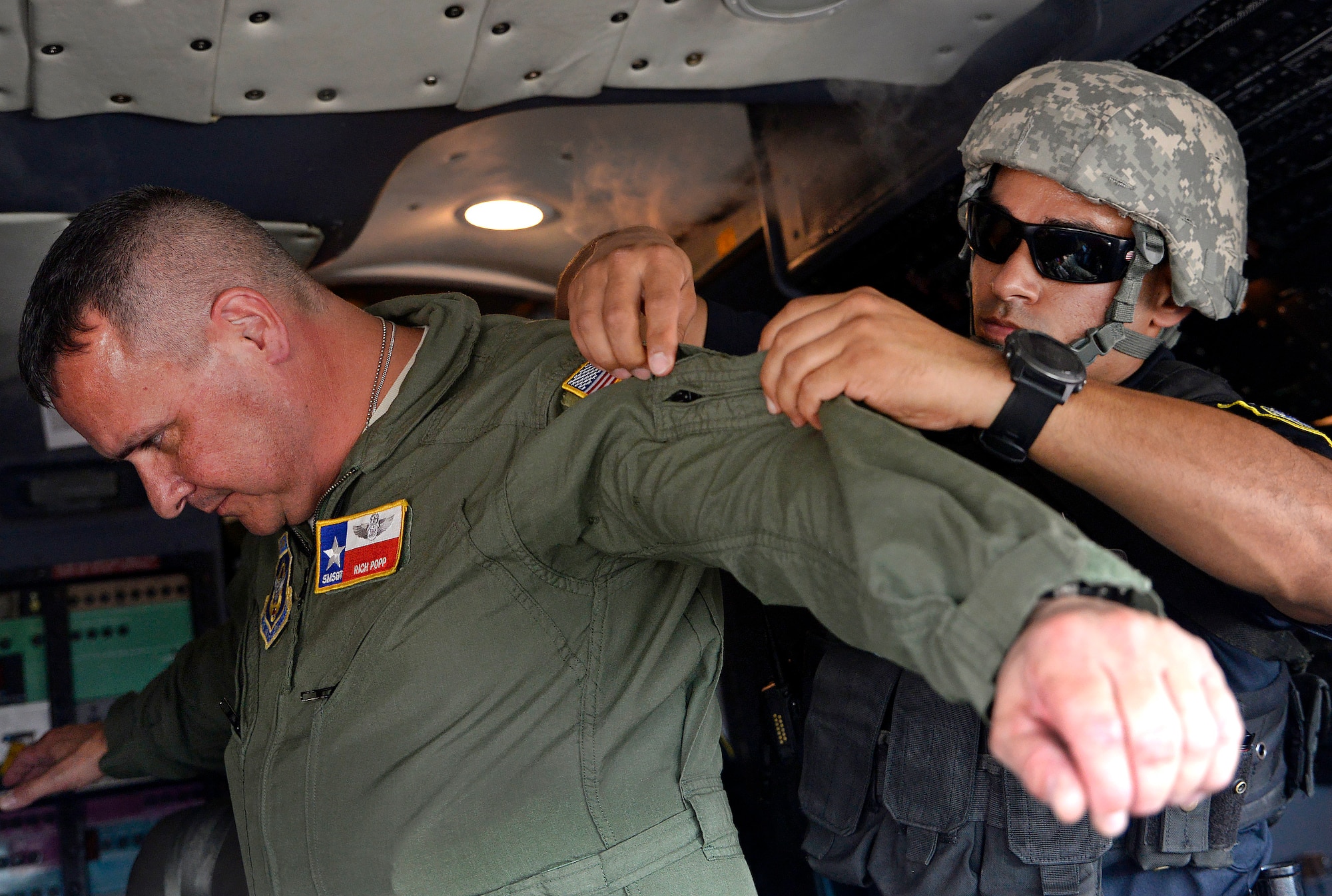 Officer Gilberto Quintero, 802nd Security Forces emergency services team member, searches Senior Master Sgt. Rich Popp, 433rd Operations Group chief loadmaster, during an anti-hijacking exercise Oct. 5, 2016 at Joint Base San Antonio-Lackland, Texas. The 502nd Air Base Wing, 433rd Airlift Wing, and 59th Medical Wing held a joint anti-hijacking exercise to evaluate emergency services reaction time to a real-world hijacking scenario. (U.S. Air Force photo by Benjamin Faske)