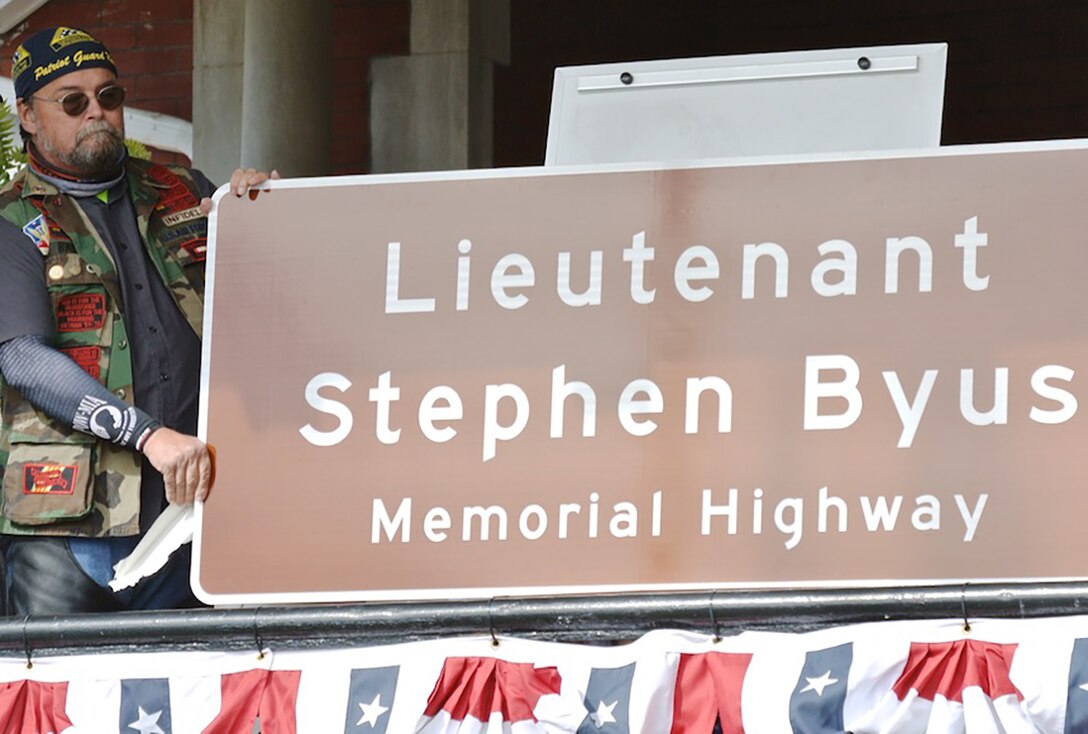 On Saturday, October 8, the community, family and friends of Stephen Byus came together to remember him with a ceremony and unveiling of a new sign. Senate Bill 182, which was enacted earlier this year, named State Route 93 from the boundaries of the City of Wellston to the Village of Coalton as the “Lieutenant Stephen Byus Memorial Highway.”