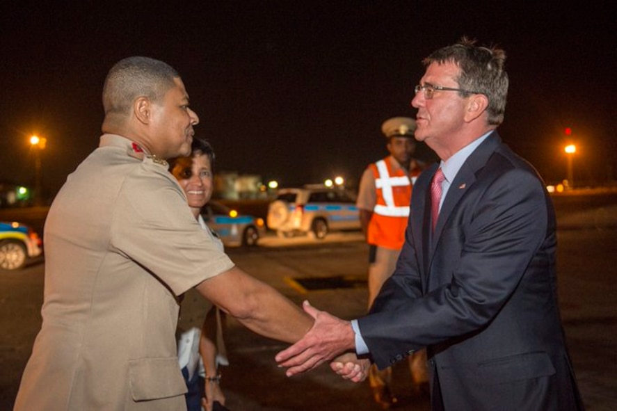 Defense Secretary Ash Carter exchanges greetings with Col. Peter Sealy, chief of staff for the Trinidad and Tobago Defense Force.