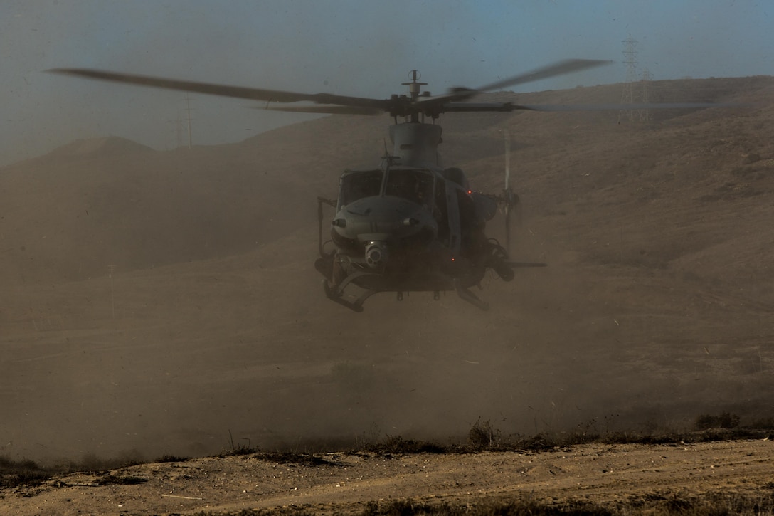 Marines with Marine Light Attack Helicopter Squadron (HMLA) 369 and 1st Reconnaissance Battalion, 1st Marine Division, take off aboard Marine Corps Base Camp Pendleton, Calif., Oct. 3.  The Marines conducted fast-rope training, which was part of a larger event called a Marine Air-Ground Task Force integration exercise and enabled air and ground units to work together in various training missions prior to their deployment with the 15th Marine Expeditionary Unit. (U.S. Marine Corps photo by Sgt. Lillian Stephens/Released)