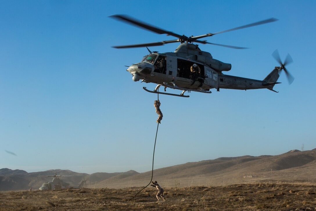 Marines with Marine Light Attack Helicopter Squadron (HMLA) 369 and 1st Reconnaissance Battalion, 1st Marine Division, conduct fast-rope training aboard Marine Corps Base Camp Pendleton, Calif., Oct. 3.  Fast roping was part of a larger event called a Marine Air-Ground Task Force integration exercise, which enabled air and ground units to come together and cooperate in various training missions prior to their deployment with the 15th Marine Expeditionary Unit. (U.S. Marine Corps photo by Sgt. Lillian Stephens/Released)