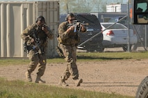 Senior Airmen Zachary Crutchfield and Anthony Fields, 791st Missile Security Forces Squadron tactical response force members, maneuver toward a resource during training at Minot Air Force Base, N.D, Sept. 28, 2016. The recapture and recovery training was designed to prepare missile response force and TRF members on how to conduct convoy response during a launch facility recapture. (U.S. Air Force photo/Airman 1st Class Jessica Weissman)
