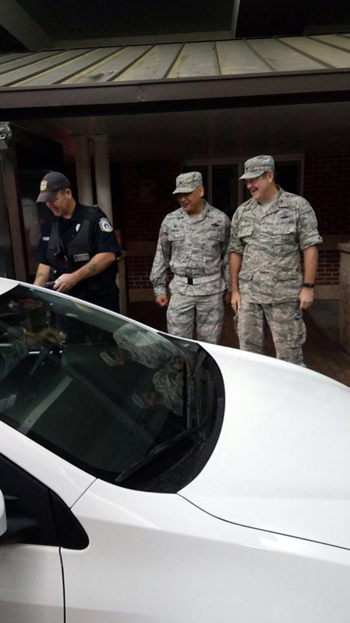 Col. Jimmy Canlas, 437th Airlift Wing commander, and Col. Gregory Gilmour, 315th AW commander welcome people back to the base Oct. 11 after the base returned to operations after evacuating because of Hurricane Matthew over the weekend.