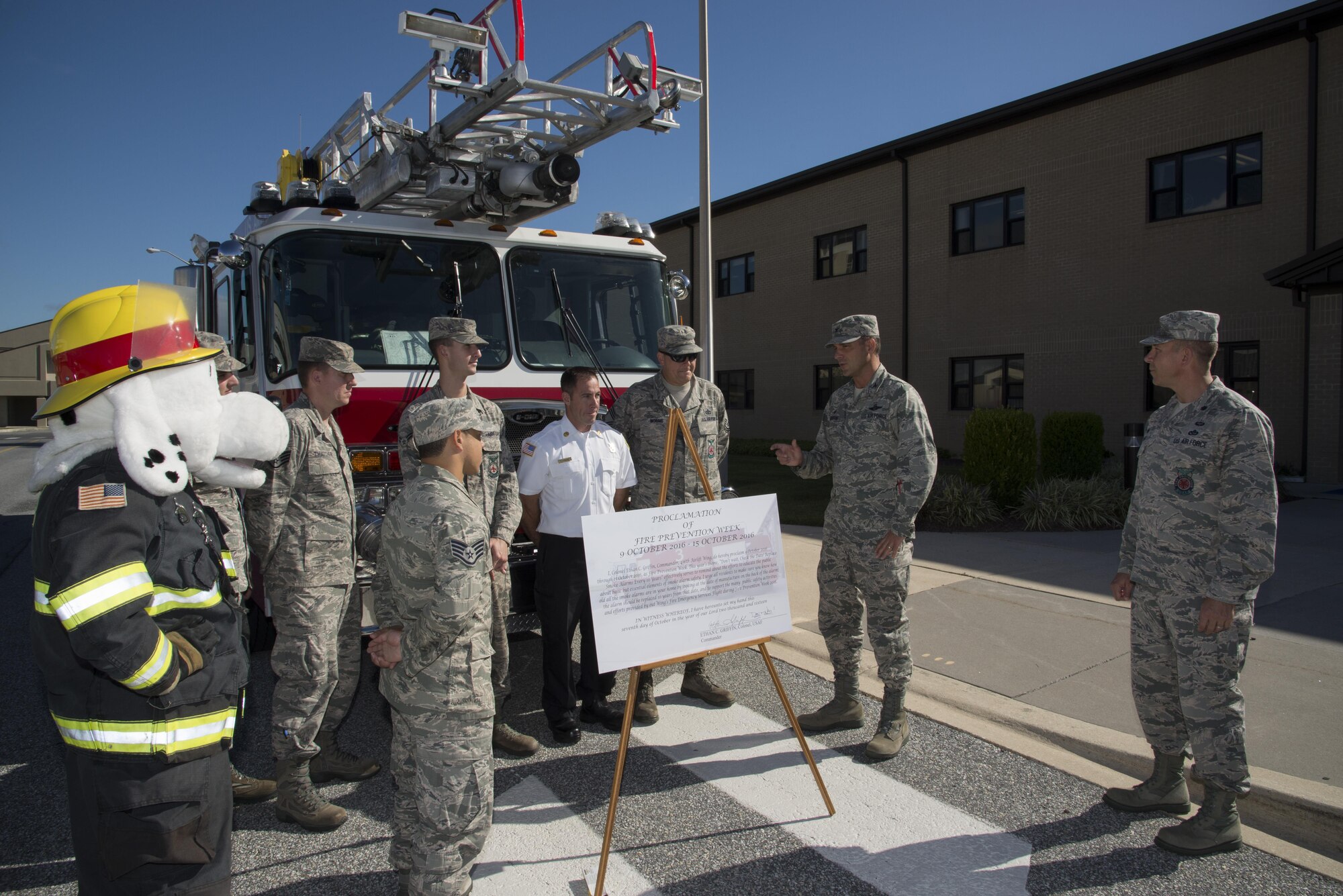 Col. Ethan Griffin, 436th Airlift Wing commander, thanks members of the 436th Civil Engineer Squadron Fire Department for their efforts to make Fire Prevention Week a success Oct. 6, 2016, at Dover Air Force Base, Del. The unit’s firefighters volunteer their time to host public events while their on-the-clock wingmen keep the installation safe. (U.S. Air Force photo by Senior Airman Aaron J. Jenne)