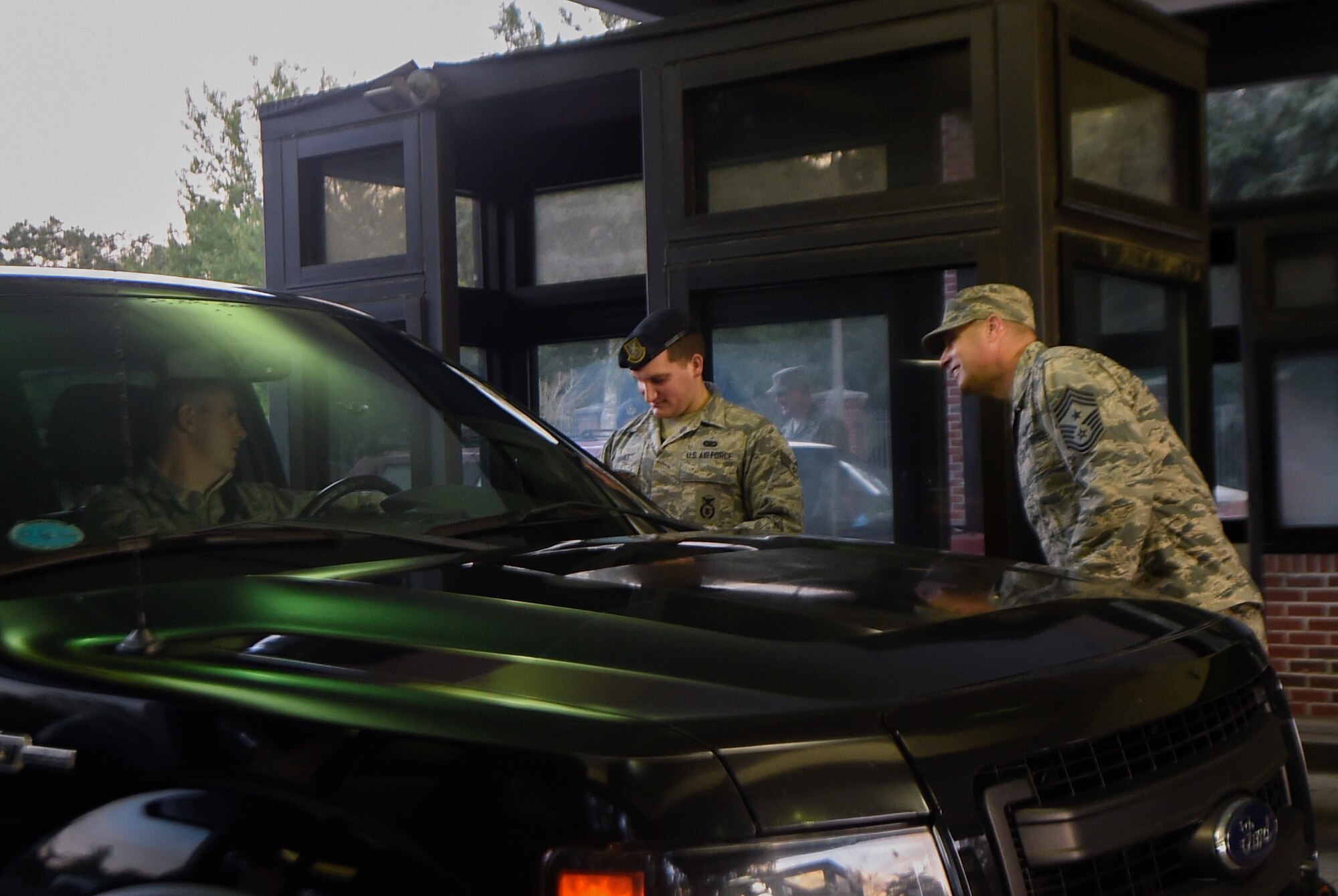 Senior Airman Hunter Banks, 628th Security Forces Squadron gate guard, and Chief Master Sgt. Todd Cole, 628th Air Base Wing command chief, welcome JB Charleston personnel entering the base, Oct. 11, 2016. Base leadership welcomed members back after the installation evacuated Oct. 5 due to Hurricane Matthew. 