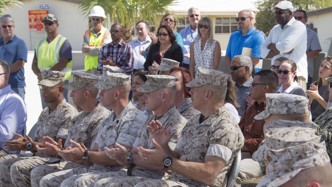 Guests attending the Victory Park ribbon-cutting ceremony applaud planners and engineers involved in the completion of Victory Park aboard Marine Corps Air Ground Combat Center, Twentynine Palms, Calif., Oct. 5, 2016. (Official Marine Corps photo by Cpl. Connor Hancock/Released)