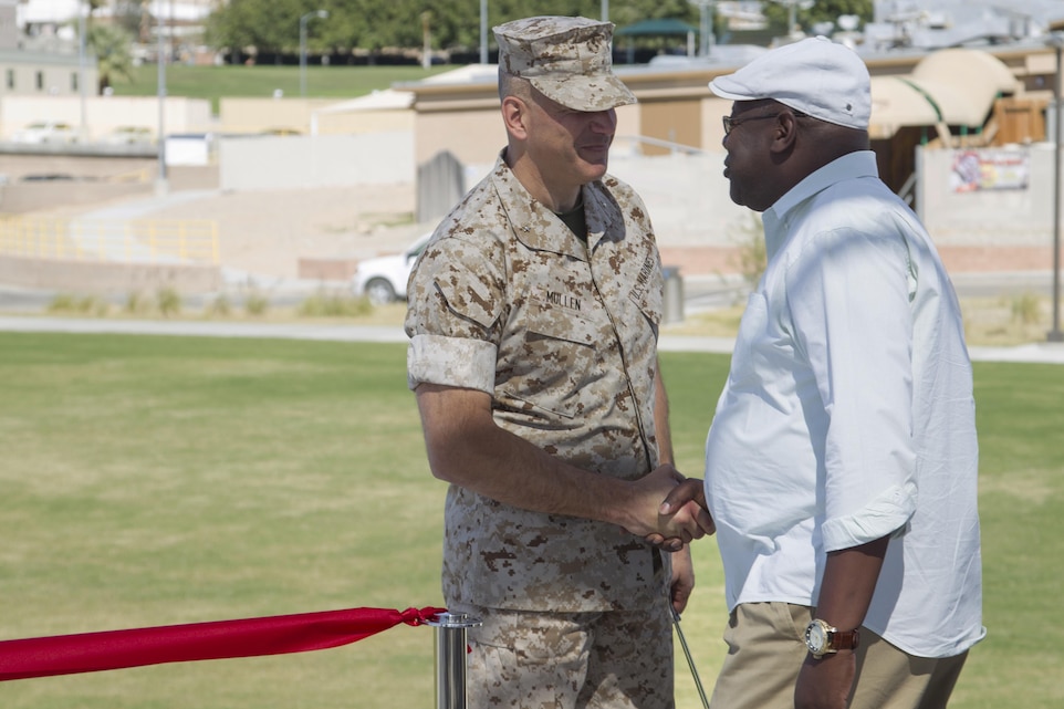 Brig. Gen. William F. Mullen III, Combat Center Commanding General, congratulates Melvin Pickens, lead facilities management specialist, Public Works Division, during the Victory Park ribbon-cutting ceremony aboard Marine Corps Air Ground Combat Center, Twentynine Palms, Calif., Oct. 5, 2016. (Official Marine Corps photo by Cpl. Connor Hancock/Released)