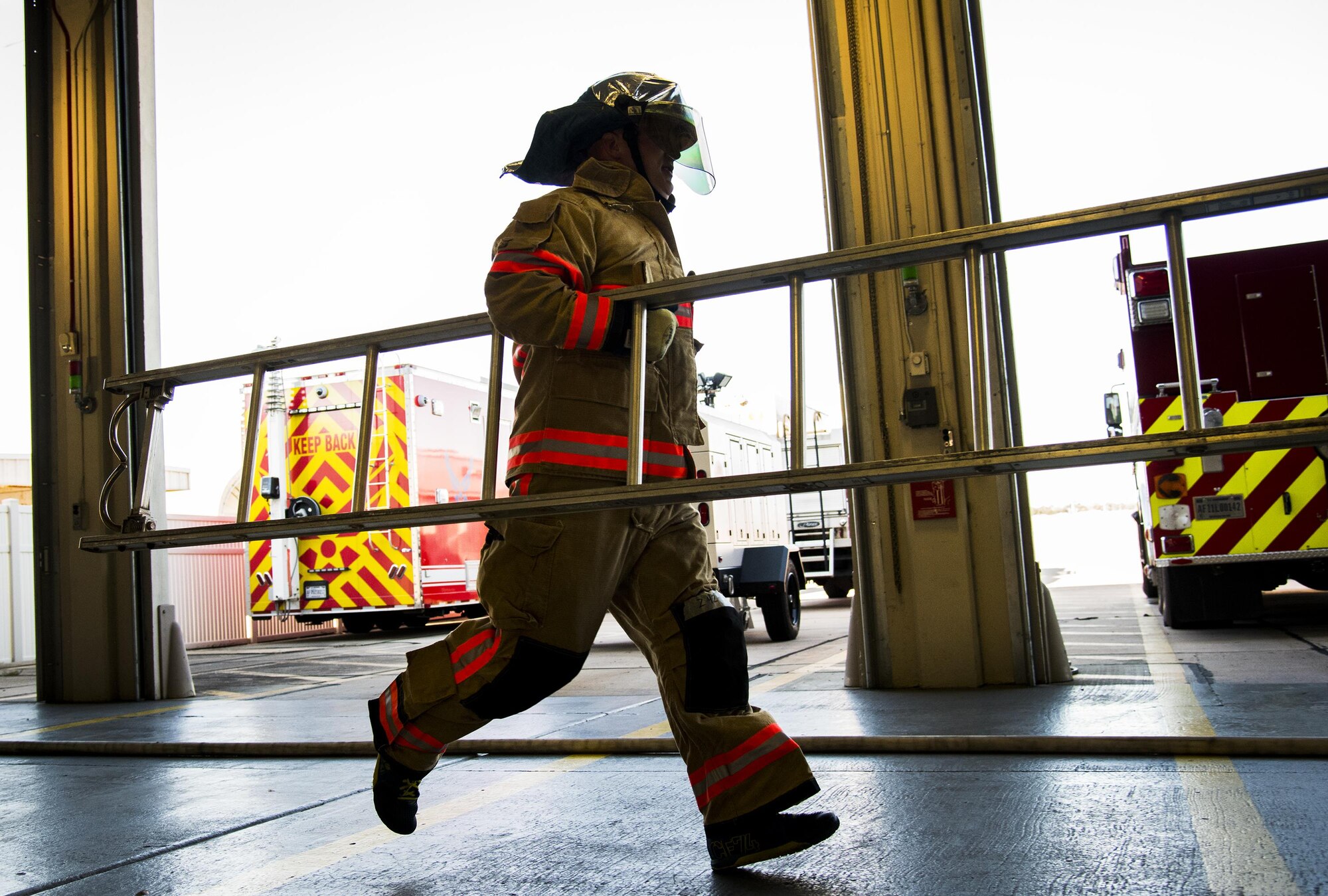 An officer carries a ladder during the firefighter fitness competition Oct. 11 at Eglin Air Force Base, Fla.  The competition pitted base enlisted and officer leadership in a duel for the best time to complete six firefighter fitness events.  The Eagles claimed victory over the Chiefs and first sergeants took the win over the squadron commanders.  (U.S. Air Force photo/Samuel King Jr.)