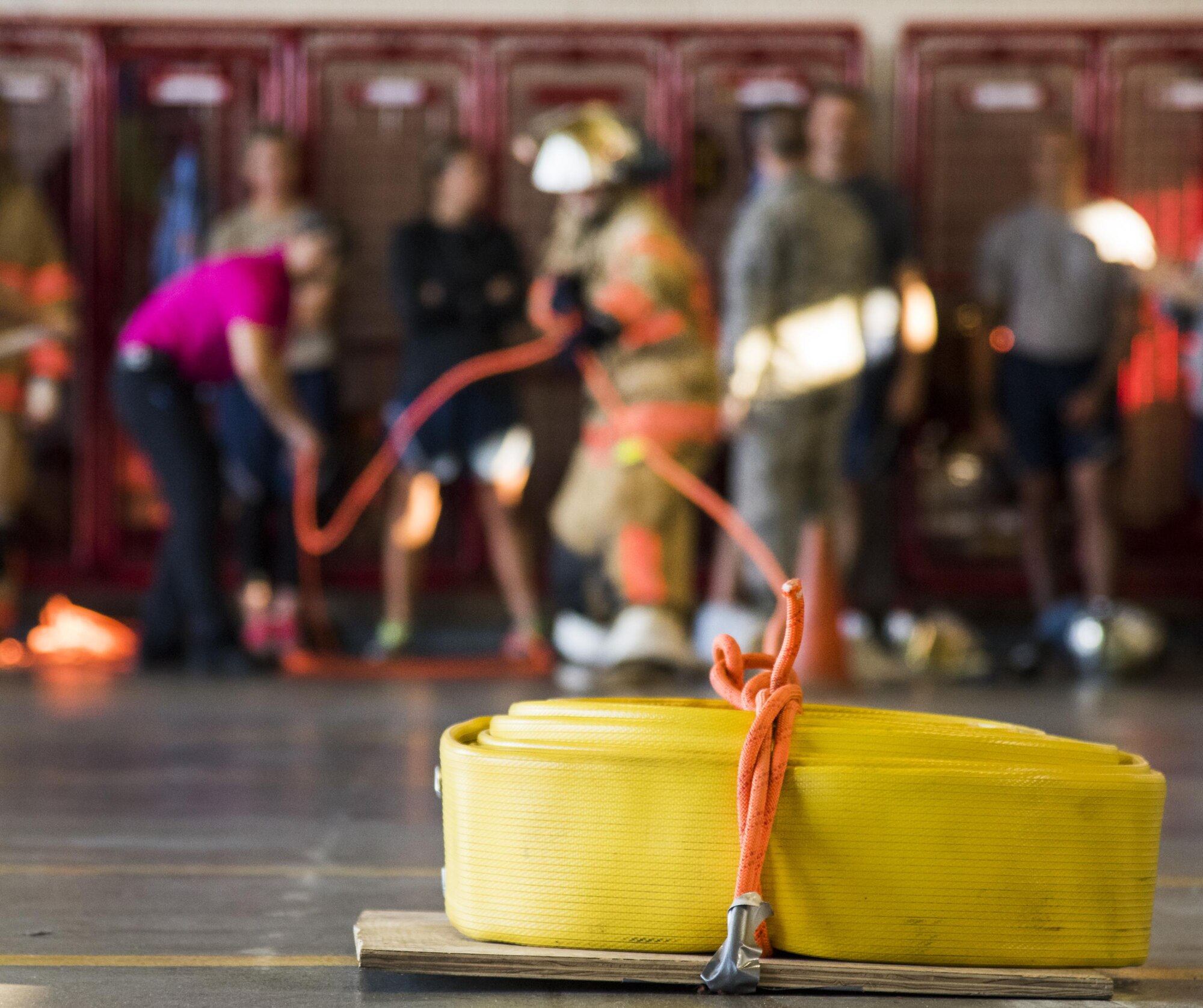 An Airman reels in a full size fire hose with a rope during the firefighter fitness competition Oct. 11 at Eglin Air Force Base, Fla.  The competition pitted base enlisted and officer leadership in a duel for the best time to complete six firefighter fitness events.  The Eagles claimed victory over the Chiefs and first sergeants took the win over the squadron commanders.  (U.S. Air Force photo/Samuel King Jr.)