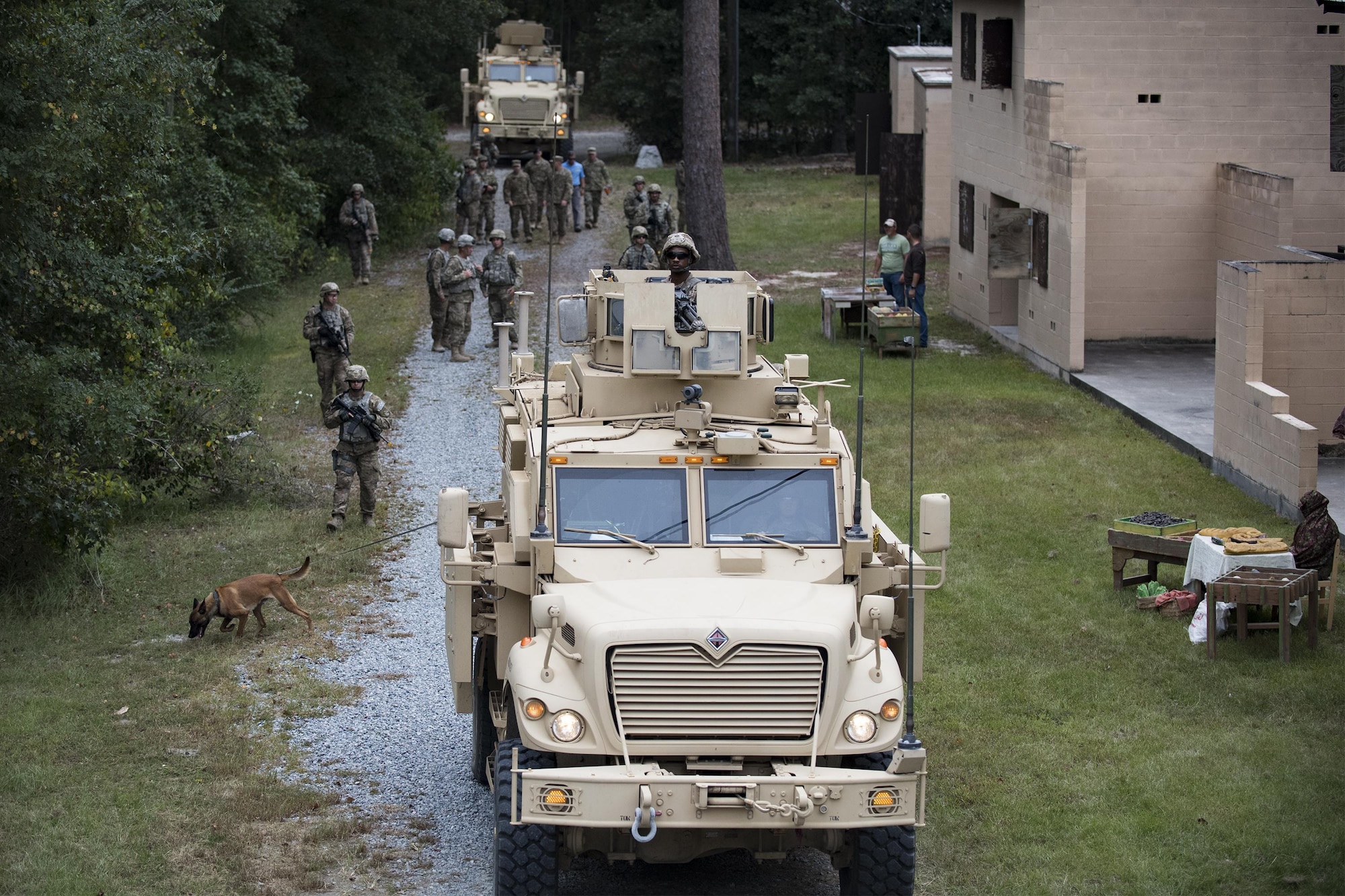 A convoy of U.S. Air Force Airmen from the 820th Base Defense Group and mine-resistant, ambush protected vehicles patrol a road Oct. 6, 2016, at Moody Air Force Base, Ga. The 820th BDG simulated a deployed environment at the military operations in an urban terrain village showcasing a variety of capabilities to include detecting improvised explosive devices and securing hostile areas during Maj. Gen. Scott Zobrist's, 9th Air Force commander, first official visit to the 93rd Air Ground Operations Wing since taking command in May 2016. He was accompanied by Chief Master Sgt. Frank H. Batten III, 9th Air Force command chief. (U.S. Air Force photo by Airman 1st Class Daniel Snider)