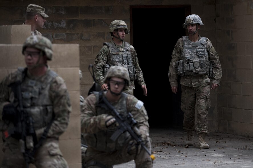 U.S. Air Force Maj. Gen. Scott Zobrist, right, 9th Air Force commander, and Staff Sgt. Jason Gebo, to his left, 820th Base Defense Group fire team leader, discuss the scenario being conducted at the military operations in an urban terrain village while 820th BDG Airmen simulate securing the area Oct. 6, 2016, at Moody Air Force Base, Ga. Chief Master Sgt. Frank H. Batten III, 9th Air Force command chief, accompanied Zobrist on his first official visit to the 93rd Air Ground Operations Wing since taking command in May 2016.
 (U.S. Air Force photo by Airman 1st Class Daniel Snider)
