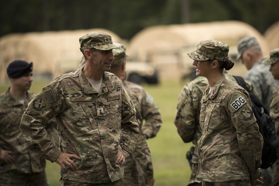 U.S. Air Force Maj. Gen. Scott Zobrist, left, 9th Air Force commander, and Staff Sgt. Leanne Combs, 824th Base Defense Squadron fire team leader, discuss mission capabilities Oct. 6, 2016, at Moody Air Force Base, Ga. The 820th Base Defense Group is composed of three security forces squadrons who maintain combat and specialty training standards and are ready to deploy at all times. This was Zobrist’s first official visit to the 93rd Air Ground Operations Wing since taking command in May 2016. He was accompanied by Chief Master Sgt. Frank H. Batten III, 9th Air Force command chief. (U.S. Air Force photo by Airman 1st Class Daniel Snider)