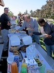 Subsistence employees enjoy a picnic lunch Oct. 5 at the NSA Philadelphia base pavilion during a Fall Fling event. Employees also played cornhole, horseshoes and "Family Food." 