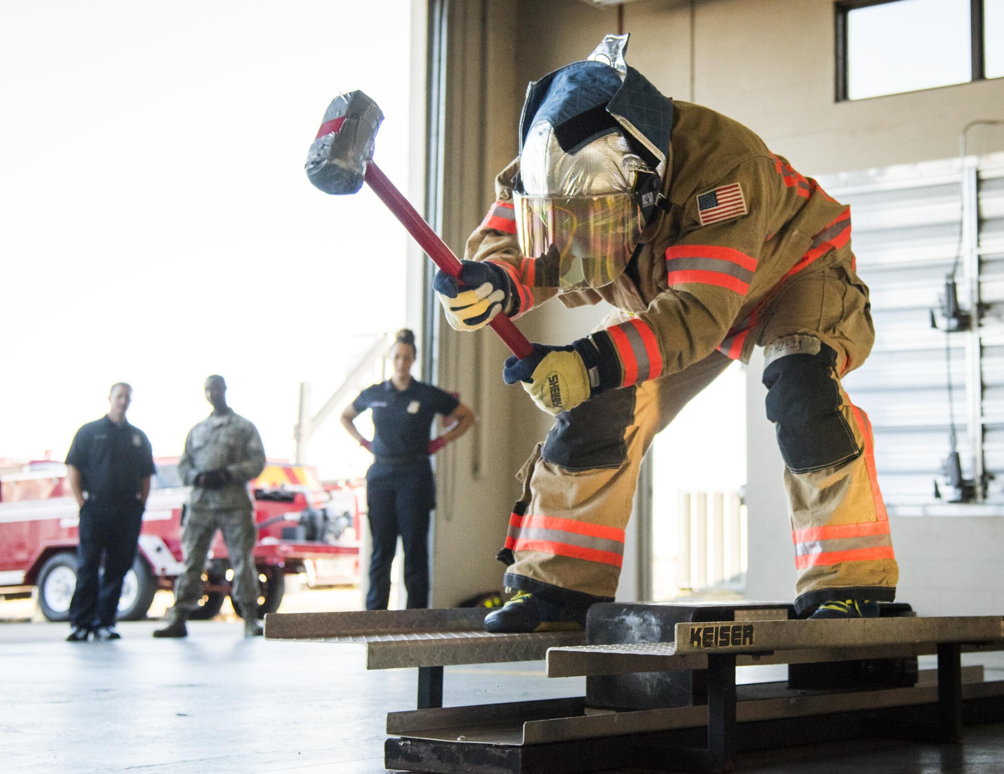 An Airman brings the hammer down during the firefighter fitness competition Oct. 11 at Eglin Air Force Base, Fla.  The competition pitted base enlisted and officer leadership in a duel for the best time to complete six firefighter fitness events.  The Eagles claimed victory over the Chiefs and first sergeants took the win over the squadron commanders.  (U.S. Air Force photo/Samuel King Jr.)