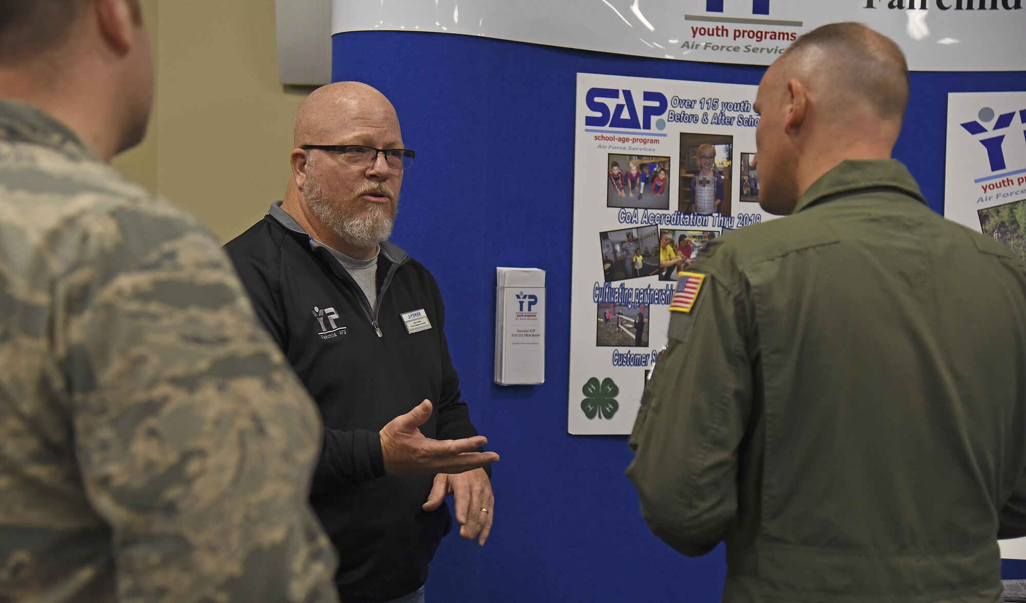 John Smith, 92nd Force Support Squadron youth programs director, discusses the impact of Fairchild’s youth programs with Col. Ryan Samuelson, 92nd Air Refueling Wing commander, during the Combined Federal Campaign Charity Fair Oct. 7, 2016, at the Red Morgan Center. The fair hosted six charities from the local area to encourage participation regardless of the monetary contribution amount. (U.S. Air Force photo/Senior Airman Mackenzie Richardson)