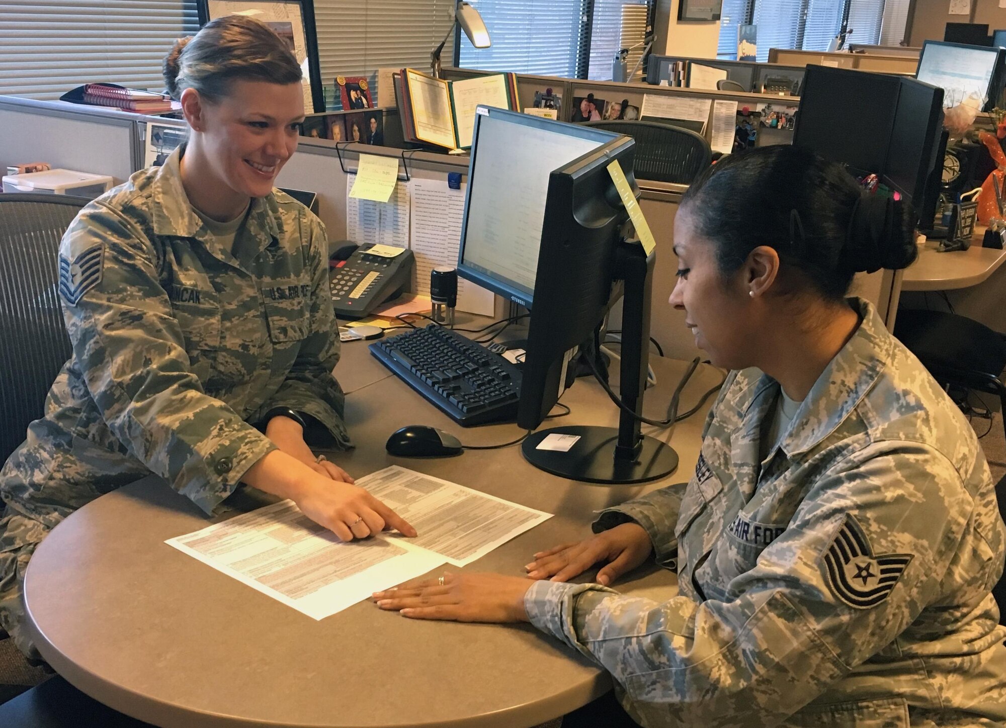 Tech. Sgt. Brandy Duncan, left, talks to Tech. Sgt. Janice Pressley about the Department of Defense Form 214. Duncan submitted an idea to Airmen Powered by Innovation to make it easier for Air Force Reservists to request the form. Duncan and Pressley are assigned to the 302nd Force Support Squadron, Peterson Air Force Base, Colo. (U.S. Air Force photo/Master Sgt. Myra Krause)	