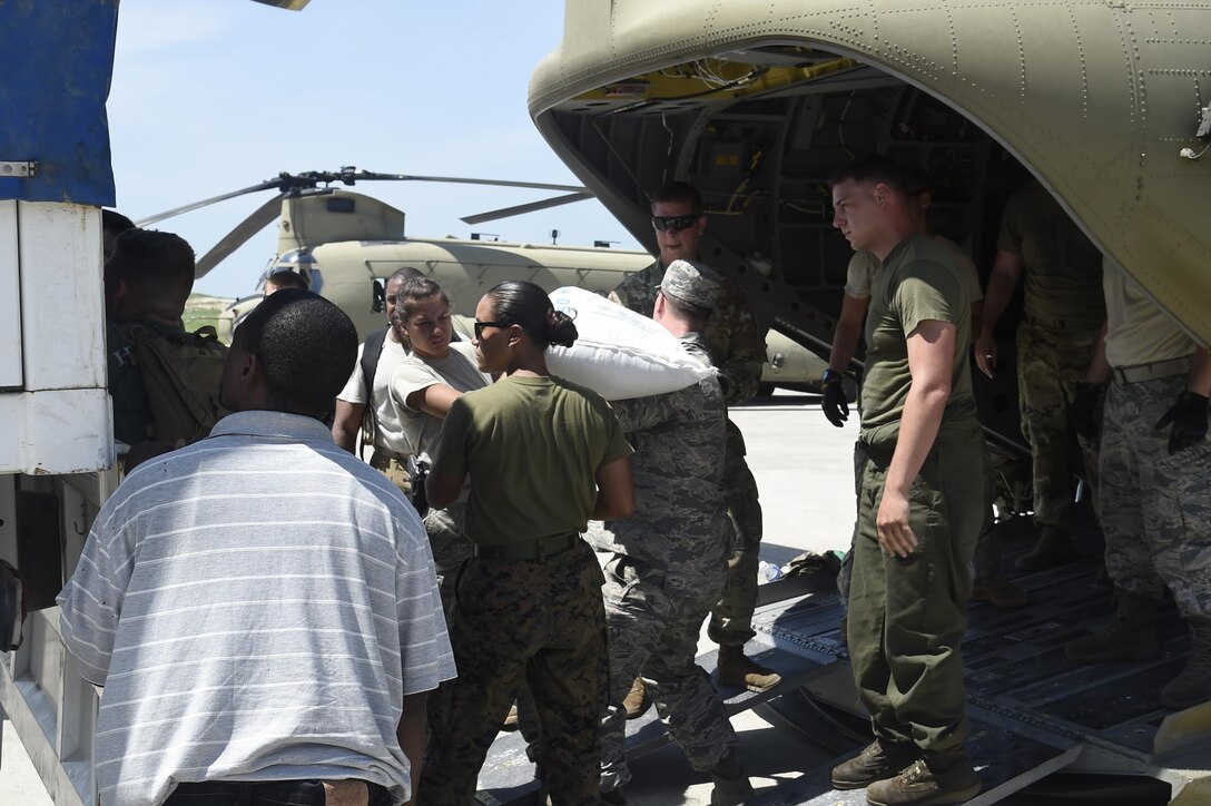 Members of the 621st Contingency Response Wing facilitate transport of USAID food and provisions for Hurricane victims in Haiti, October 9th, 2016, Port-Au-Prince, Haiti. The CRW has units ready to deploy anywhere in the world in support of emergency operations, within 12 hours of notification.(U.S. Air Force photo by Staff Sgt. Robert Waggoner/released)