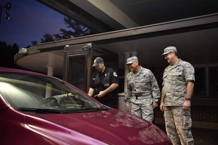 Col. Jimmy Canlas (center), 437th Airlift Wing commander, Col. Gregory Gilmour (right), 315th Airlift Wing commander and Sean Burridge, 628th Security Forces Squadron installation patrolman, greet Joint Base Charleston members at the Rivers Avenue Gate here as they return to work Oct. 11, 2016 following a hurricane evacuation. The base was evacuated Oct. 5, 2016 in preparation for Hurricane Matthew and returned to normal operations Oct. 11.