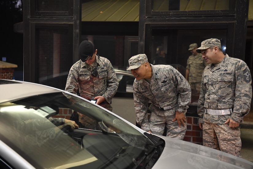 Col. Jimmy Canlas (center), 437th Airlift Wing commander, Chief Master Sgt. Kristopher Berg (right), 437th Airlift Wing command chief and Senior Airman Billy Meadows (left), 628th Security Forces Squadron installation patrolman, greet Joint Base Charleston members at the Rivers Avenue Gate  here Oct. 11, 2016 as they return to work from following a hurricane evacuation. The base was evacuated Oct. 5, 2016, in preparation for Hurricane Matthew, and the base returned to normal operations Oct. 11. 