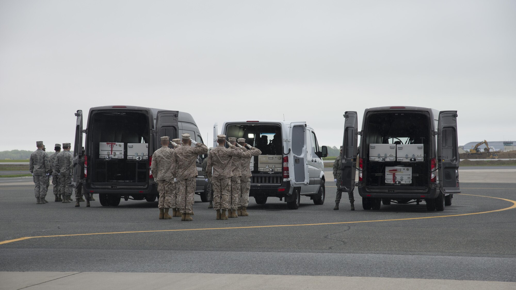 A U.S. Marine Corps carry team salutes after placing an empty transfer case into a transfer vehicle during the Folded Flag 2016 mass fatality dignified transfer exercise May 4, 2016, at Dover Air Force Base, Del. Two more transfer vehicles are expected to join the Air Force Mortuary Affairs Operations fleet in the upcoming months. (U.S. Air Force photo by Senior Airman Zachary Cacicia)