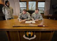 (From left) Tech Sgt. Cornelia Justice, 5th Bomb Wing staff judge advocate NCO in charge of military justice and Combined Federal Campaign representative, watches Col. Matthew Brooks, 5th BW commander, and Chief Master Sgt. Paul Elliott, 5th BW command chief, donate to the Combined Federal Campaign at Minot Air Force Base, N.D., Oct. 7, 2016. In 2015, the total amount contributed by both military and civilian donors in Minot AFB was $110,000. This year, Team Minot's campaign runs until Oct. 22, 2016, with a goal of $125,000. (U.S. Air Force photo/Airman 1st Class J.T. Armstrong)