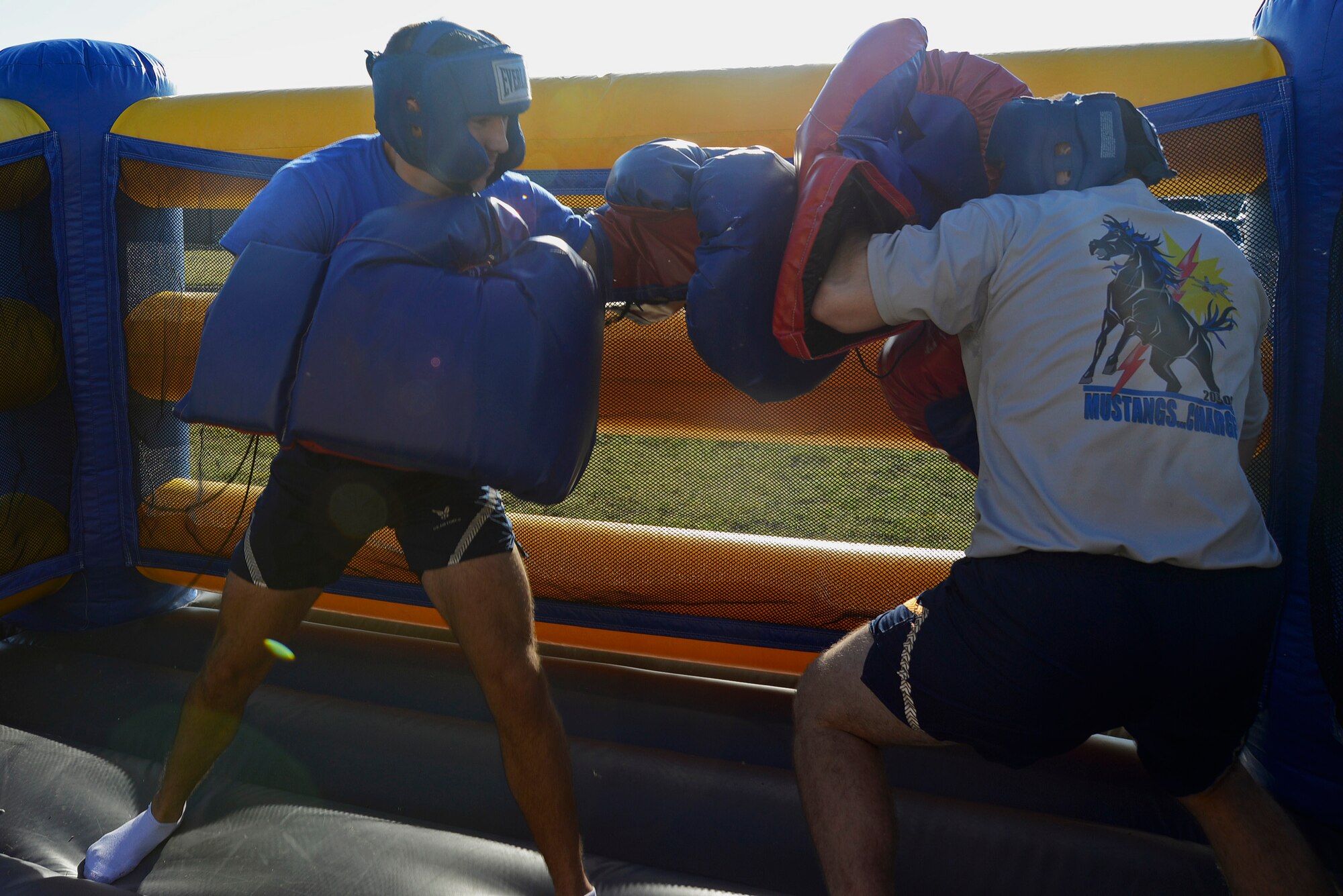 U.S. Air Force 1st Lt. Ken Blechler, 55th Fighter Squadron pilot and Senior Airman Derrik Bush, 20th Operations Support Squadron operations coordinator, compete with inflatable boxing gloves in a bouncy house at Shaw Air Force Base, S.C., Sept. 30, 2016. Inflatable boxing was one of many games that took place at the 20th Operations Group Olympics, which was designed to boost morale and give Airmen an opportunity to interact with wingmen from different squadrons. (U.S. Air Force photo by Airman BrieAnna Stillman) 