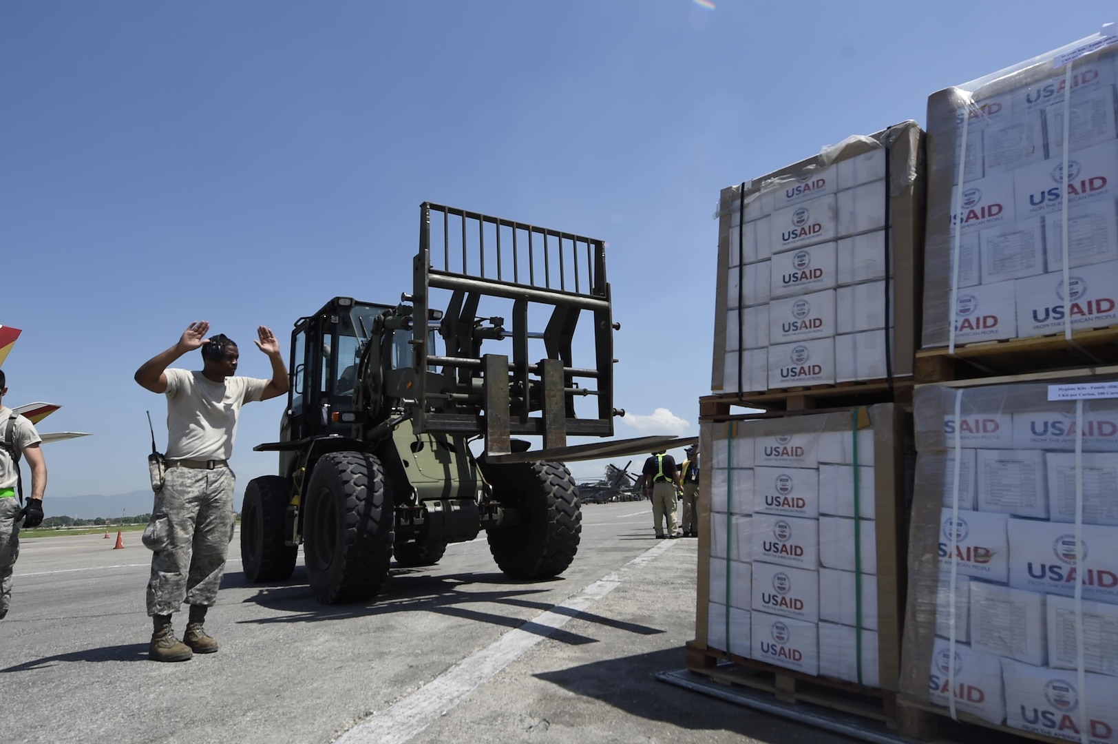 Tech. Sgt. Ronald Rowe, 621st Contingency Response Wing, facilitates transport of USAID food and provisions for Hurricane victims in Haiti, October 9th, 2016, Port-Au-Prince, Haiti. The CRW has units ready to deploy anywhere in the world in support of emergency operations, within 12 hours of notification.(U.S. Air Force photo by Staff Sgt. Robert Waggoner/released)