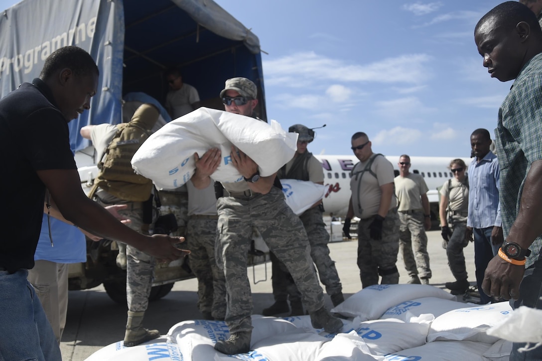 Staff Sgt. Angelo Morino, 621st Contingency Response Wing, transports food and provisions for Hurricane victims, October 9th, 2016, Port-Au-Prince, Haiti. The CRW has units ready to deploy anywhere in the world in support of emergency operations, within 12 hours of notification.(U.S. Air Force photo by Staff Sgt. Robert Waggoner/released)