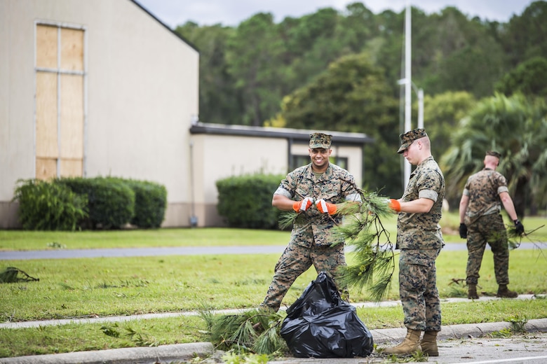 Marines clear debris from a main road aboard Marine Corps Air Station Beaufort Oct. 8. Marines and sailors with MCAS Beaufort worked to return the air station and Laurel Bay to normal operations. They removed debris and cleaned up main access roads to establish infrastructure after Hurricane Matthew.