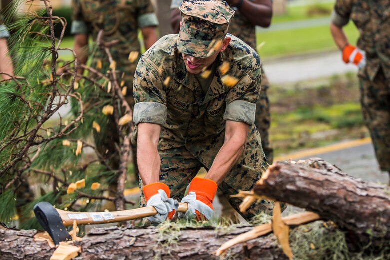 A Marine chops a fallen tree at a main road aboard Marine Corps Air Station Beaufort Oct. 8. Marines and sailors with MCAS Beaufort worked to return the air station and Laurel Bay to normal operations. They removed debris and cleaned up main access roads to establish infrastructure after Hurricane Matthew.